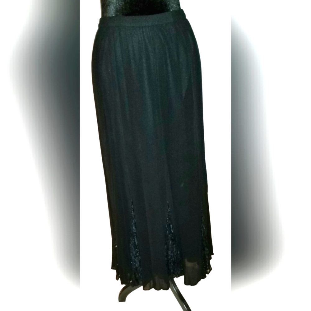 Black maxi skirt with 8 lace insets along hemline.